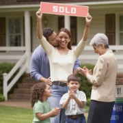 A happy family in front of their new home