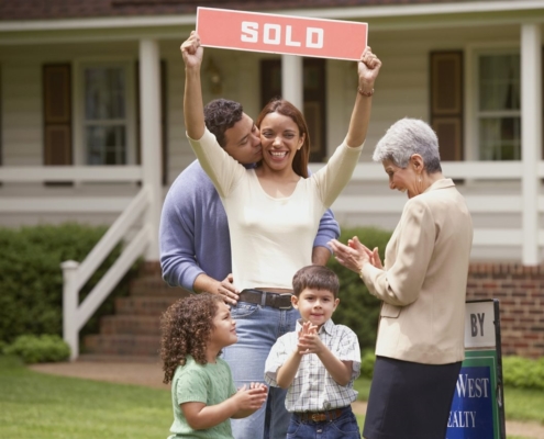 A happy family in front of their new home