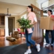 a man and a girl moving plants and carton inside the house | On Target Home Inspection | Door Orland Park