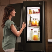 a woman opening a fridge | On Target Home Inspection | Kitchen Orland Park