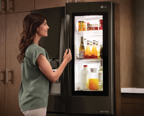 a woman opening a fridge | On Target Home Inspection | Kitchen Orland Park